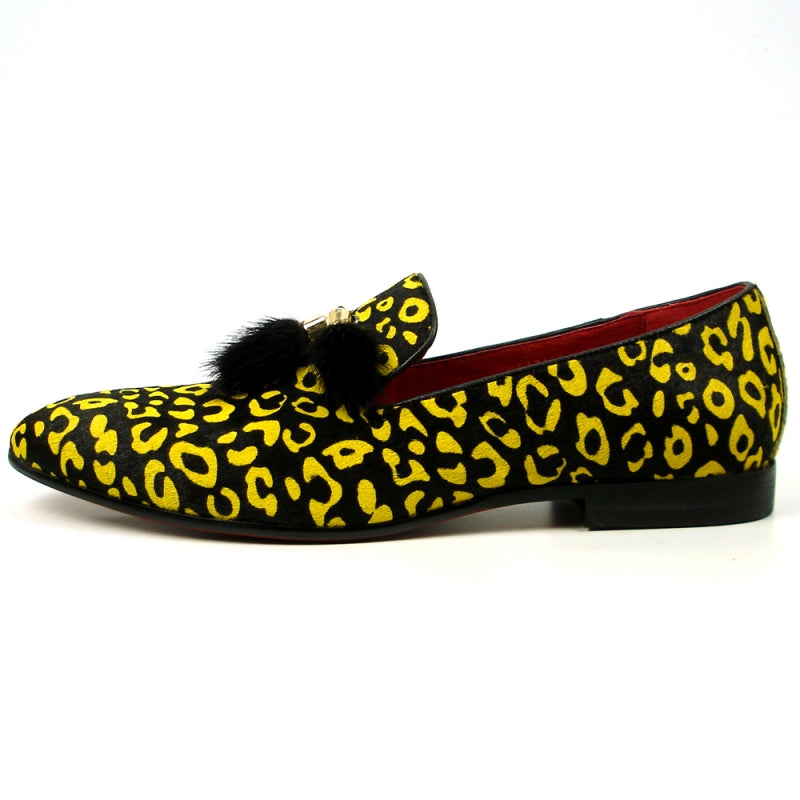 The FI-7402 Black Yellow Leopard Fiesso by Aurelio Garcia loafer from Fiesso showcases a leather upper in a striking yellow and black leopard print, complemented by a red interior and adorned with black tassels on top.