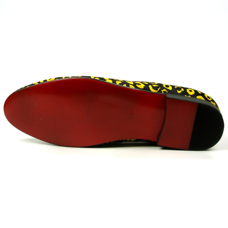 The FI-7402 Black Yellow Leopard Fiesso by Aurelio Garcia loafer from Fiesso showcases a leather upper in a striking yellow and black leopard print, complemented by a red interior and adorned with black tassels on top.