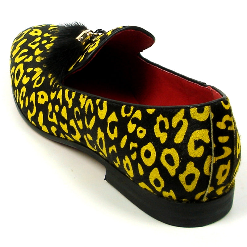 The FI-7402 Black Yellow Leopard Fiesso by Aurelio Garcia loafer from Fiesso showcases a leather upper in a striking yellow and black leopard print, complemented by a red interior and adorned with black tassels on top.