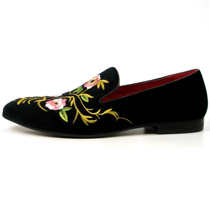 The FI-7409 Black Slip on by Fiesso showcases a luxurious black suede upper adorned with pink and yellow floral embroidery, complemented by a vibrant red interior lining. As part of the Fiesso by Aurelio Garcia collection, this loafer blends luxury with artistry for a truly standout style.