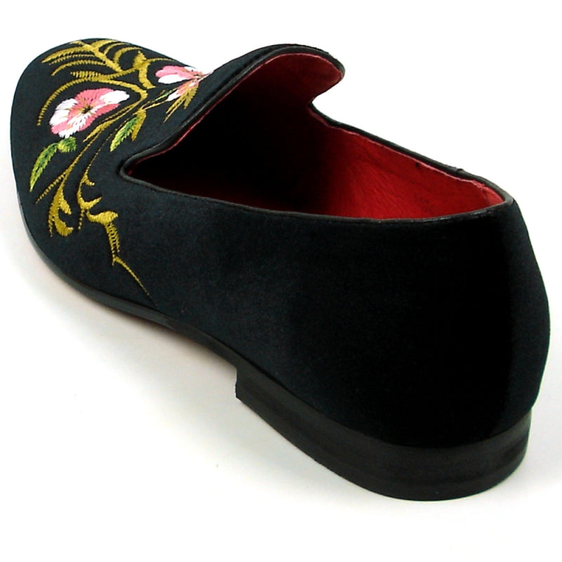 The FI-7409 Black Slip on by Fiesso showcases a luxurious black suede upper adorned with pink and yellow floral embroidery, complemented by a vibrant red interior lining. As part of the Fiesso by Aurelio Garcia collection, this loafer blends luxury with artistry for a truly standout style.