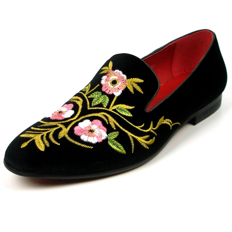 The FI-7409 Black Slip on by Fiesso showcases a luxurious black suede upper adorned with pink and yellow floral embroidery, complemented by a vibrant red interior lining. As part of the Fiesso by Aurelio Garcia collection, this loafer blends luxury with artistry for a truly standout style.