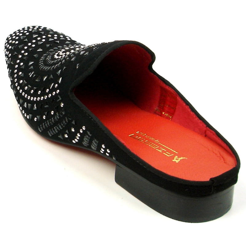 The FI-7420 Black Suede slip-on shoe by Fiesso features a suede upper adorned with decorative silver studs and a red interior. Designed by Aurelio Garcia, it includes a cushioned insole for enhanced comfort.