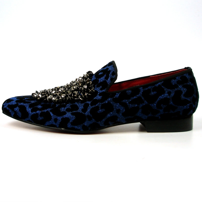 Introducing the FI-7421 Blue Slip-on by Fiesso, a stylish fashion shoe from the Fiesso brand. This design features a striking blue and black leopard print with a luxurious velvet upper, adorned with silver embellishments on the top, and completed with a vibrant red interior to ensure both style and comfort.