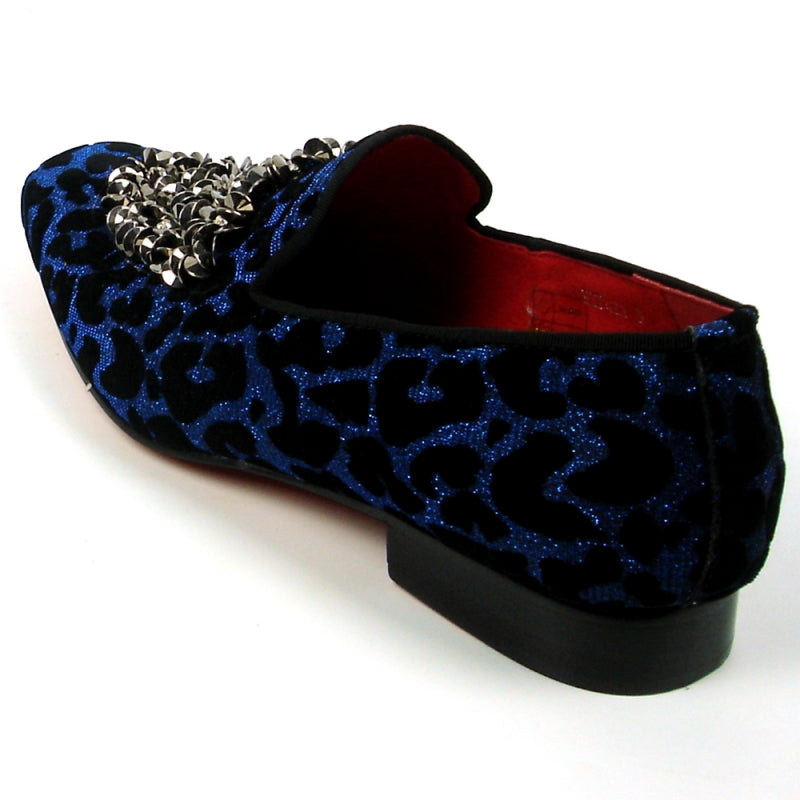 Introducing the FI-7421 Blue Slip-on by Fiesso, a stylish fashion shoe from the Fiesso brand. This design features a striking blue and black leopard print with a luxurious velvet upper, adorned with silver embellishments on the top, and completed with a vibrant red interior to ensure both style and comfort.