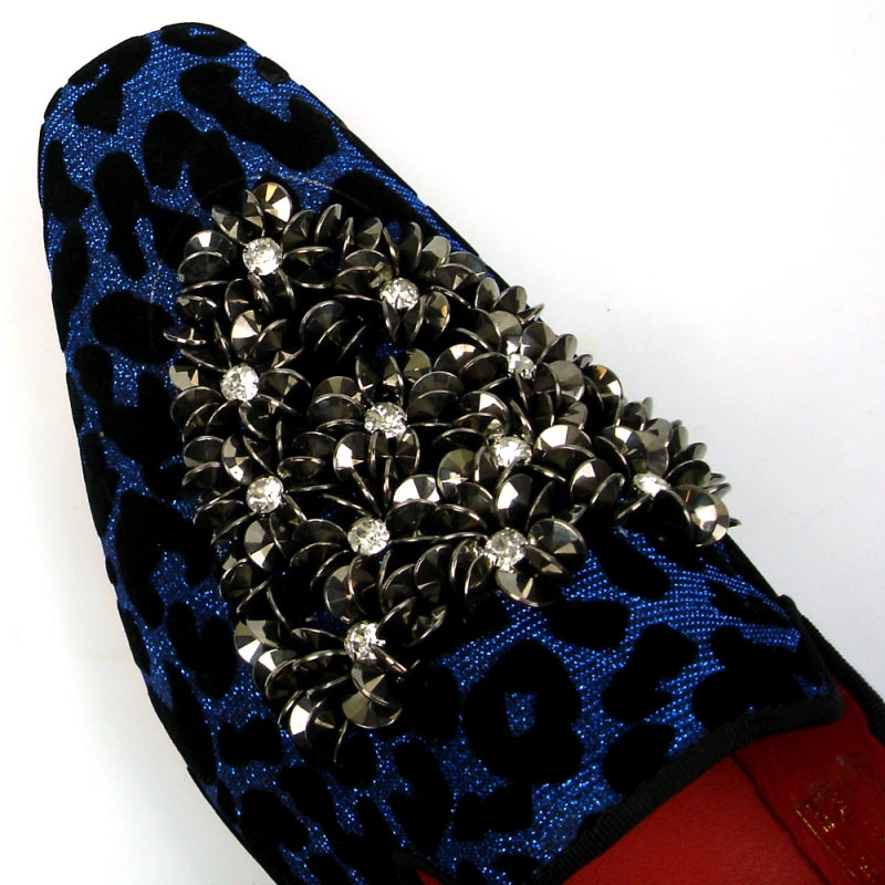 Introducing the FI-7421 Blue Slip-on by Fiesso, a stylish fashion shoe from the Fiesso brand. This design features a striking blue and black leopard print with a luxurious velvet upper, adorned with silver embellishments on the top, and completed with a vibrant red interior to ensure both style and comfort.