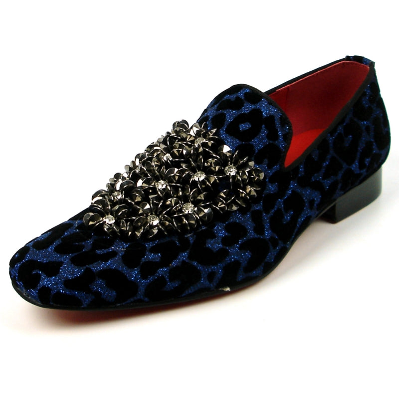 Introducing the FI-7421 Blue Slip-on by Fiesso, a stylish fashion shoe from the Fiesso brand. This design features a striking blue and black leopard print with a luxurious velvet upper, adorned with silver embellishments on the top, and completed with a vibrant red interior to ensure both style and comfort.