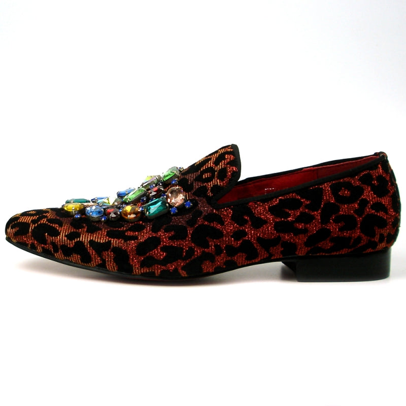 The FI-7422 Leopard Slip on Fiesso by Aurelio Garcia from the brand Fiesso showcases a striking red and black leopard print pattern, adorned with multicolored gem embellishments at the top. Its velvet upper exudes luxury, while the cushioned insole guarantees comfort with every step.