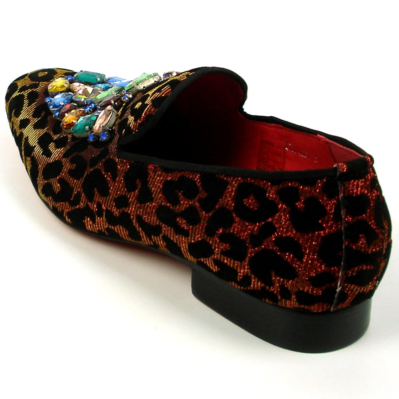 The FI-7422 Leopard Slip on Fiesso by Aurelio Garcia from the brand Fiesso showcases a striking red and black leopard print pattern, adorned with multicolored gem embellishments at the top. Its velvet upper exudes luxury, while the cushioned insole guarantees comfort with every step.