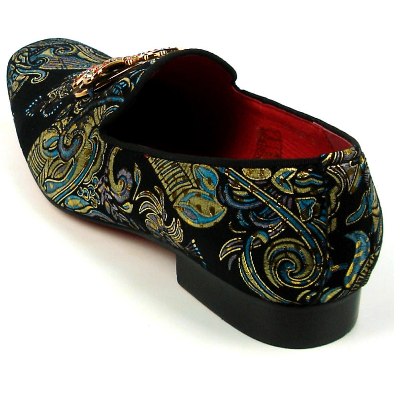 The Fiesso shoe by Aurelio Garcia, known as the FI-7427 Blue Slip on Butterfly, features a striking design with an ornate butterfly embellishment and colorful gemstones adorning its leather upper.