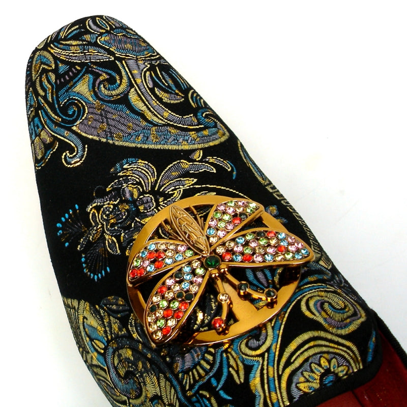 The Fiesso shoe by Aurelio Garcia, known as the FI-7427 Blue Slip on Butterfly, features a striking design with an ornate butterfly embellishment and colorful gemstones adorning its leather upper.