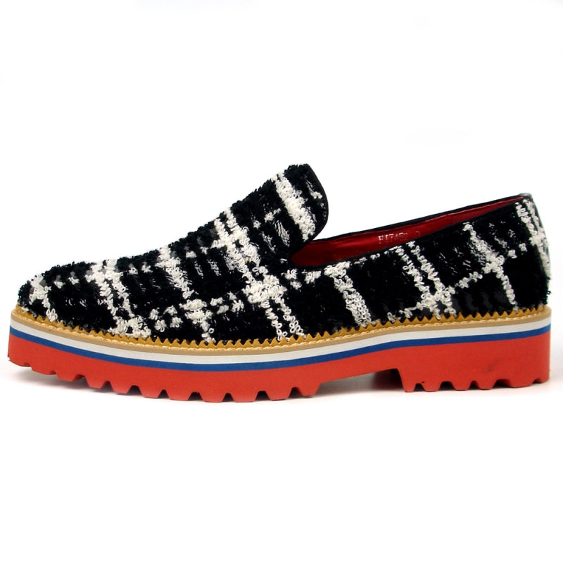 Introducing the FI-7452 Black Slip On by Fiesso, crafted by Aurelio Garcia, this stylish shoe showcases a striking black and white checkered fabric design with a vibrant red interior. It features a thick sole in bold shades of red, white, and blue. This comfortable slip-on design also includes a cushioned insole for enhanced comfort with every step.