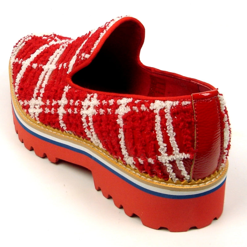 The FI-7452 Red Slip-On Fiesso by Aurelio Garcia is a fashion shoe that showcases a red and white plaid texture, complemented by a chunky red sole, blue trim, and leather upper.