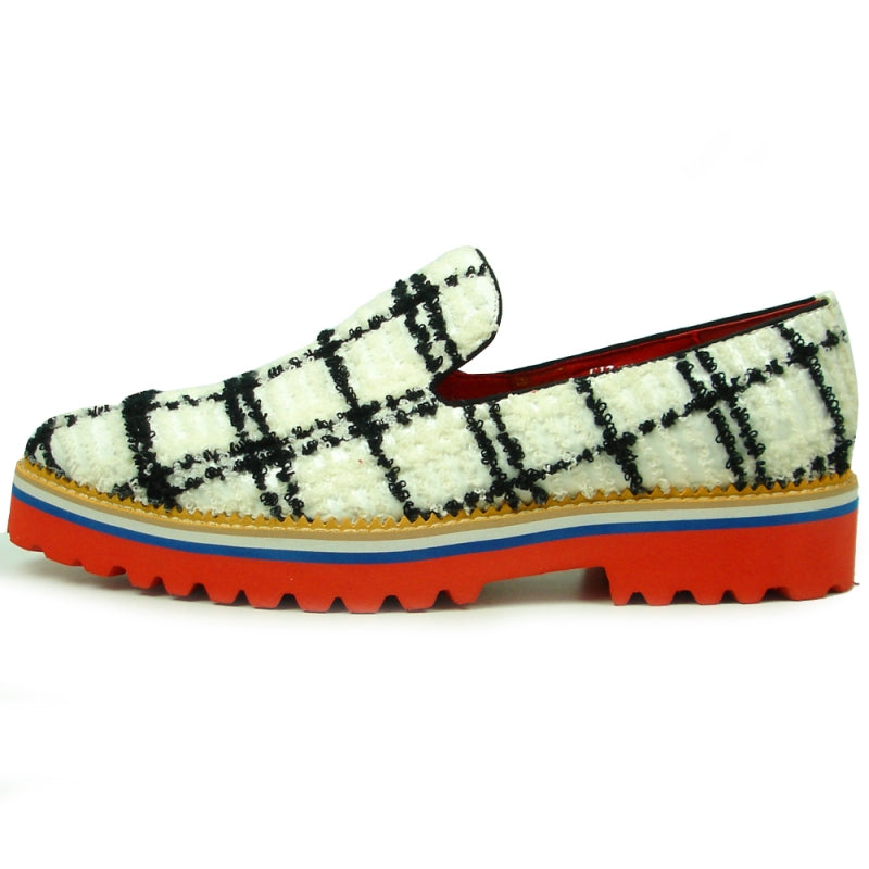 Featuring a black and white plaid pattern, the FI-7452 White Slip-On by Fiesso highlights a leather upper and vibrant red interior. The layered sole showcases red, blue, white, and rubber brown hues with a chunky tread, perfectly embodying the distinctive style of Fiesso by Aurelio Garcia.