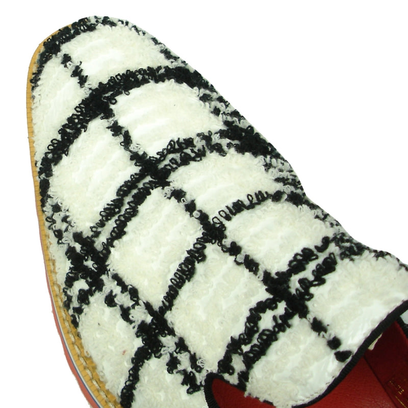 Featuring a black and white plaid pattern, the FI-7452 White Slip-On by Fiesso highlights a leather upper and vibrant red interior. The layered sole showcases red, blue, white, and rubber brown hues with a chunky tread, perfectly embodying the distinctive style of Fiesso by Aurelio Garcia.