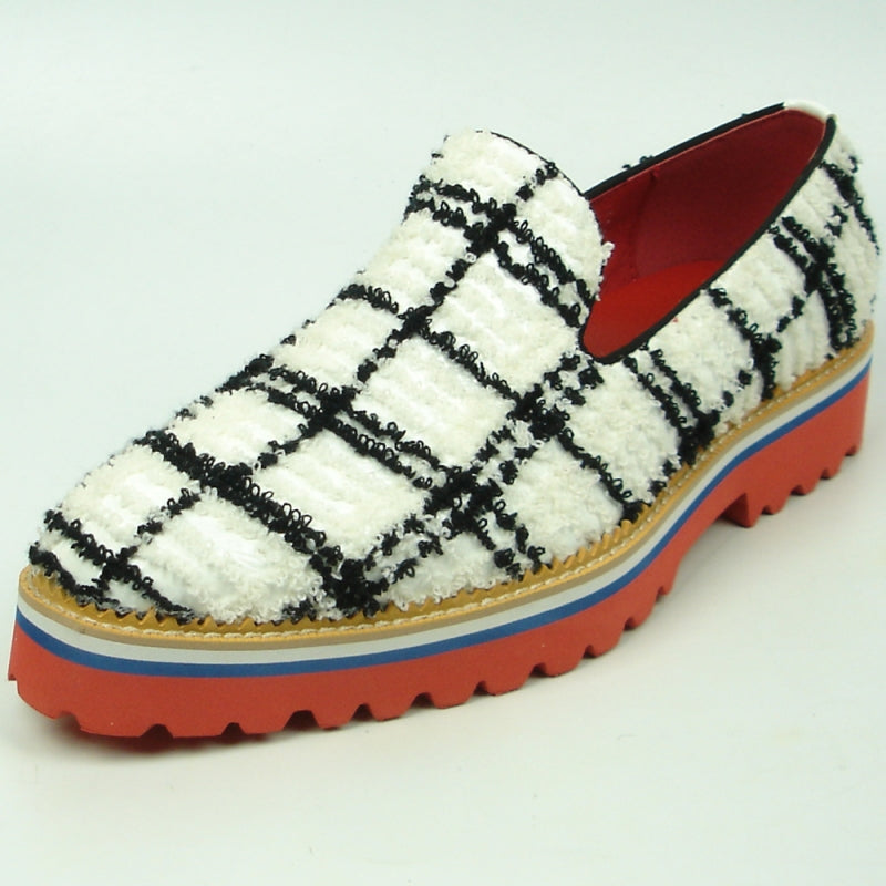 Featuring a black and white plaid pattern, the FI-7452 White Slip-On by Fiesso highlights a leather upper and vibrant red interior. The layered sole showcases red, blue, white, and rubber brown hues with a chunky tread, perfectly embodying the distinctive style of Fiesso by Aurelio Garcia.