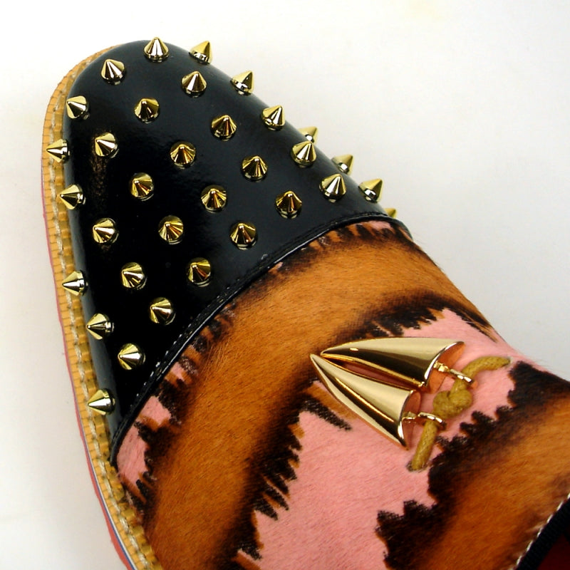 The FI-7455 Pink Slip on Fiesso by Aurelio Garcia showcases a vibrant design with a thick red sole, blending black, brown, and pink patterns. It is adorned with striking gold spikes and features a distinctive gold triangular embellishment.