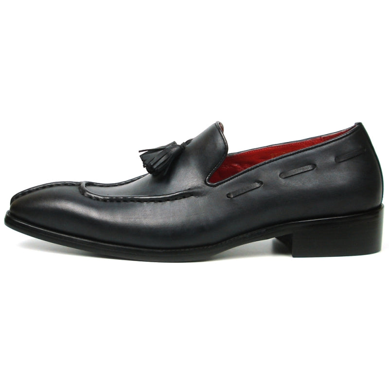 The FI-8701 Black Encore by Fiesso is a sophisticated leather loafer featuring elegant tassels, a luxurious red interior, and a low heel, perfect for those who appreciate high fashion shoes with timeless sophistication.