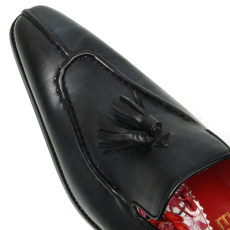 The FI-8701 Black Encore by Fiesso is a sophisticated leather loafer featuring elegant tassels, a luxurious red interior, and a low heel, perfect for those who appreciate high fashion shoes with timeless sophistication.