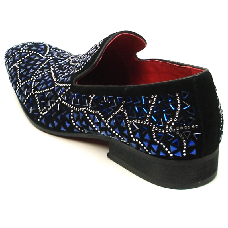 The FI-7415 Black Suede Blue Stone shoe by Fiesso boasts a black slip-on design adorned with a geometric pattern of blue and silver embellishments and is highlighted by a vibrant red interior lining.