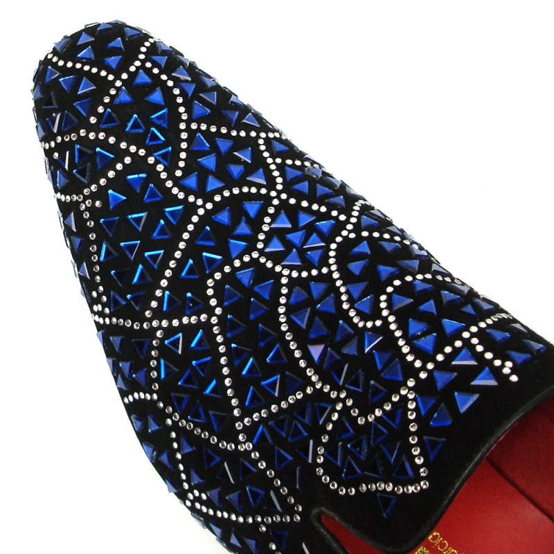 The FI-7415 Black Suede Blue Stone shoe by Fiesso boasts a black slip-on design adorned with a geometric pattern of blue and silver embellishments and is highlighted by a vibrant red interior lining.