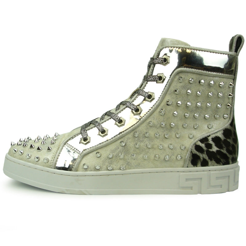 The FI-2364 Silver High Top Sneaker Encore by Fiesso showcases a sleek metallic finish, complete with spikes and a robust white sole. Luxurious leather accents enhance its modern design edge, making it a standout piece from the Fiesso brand.