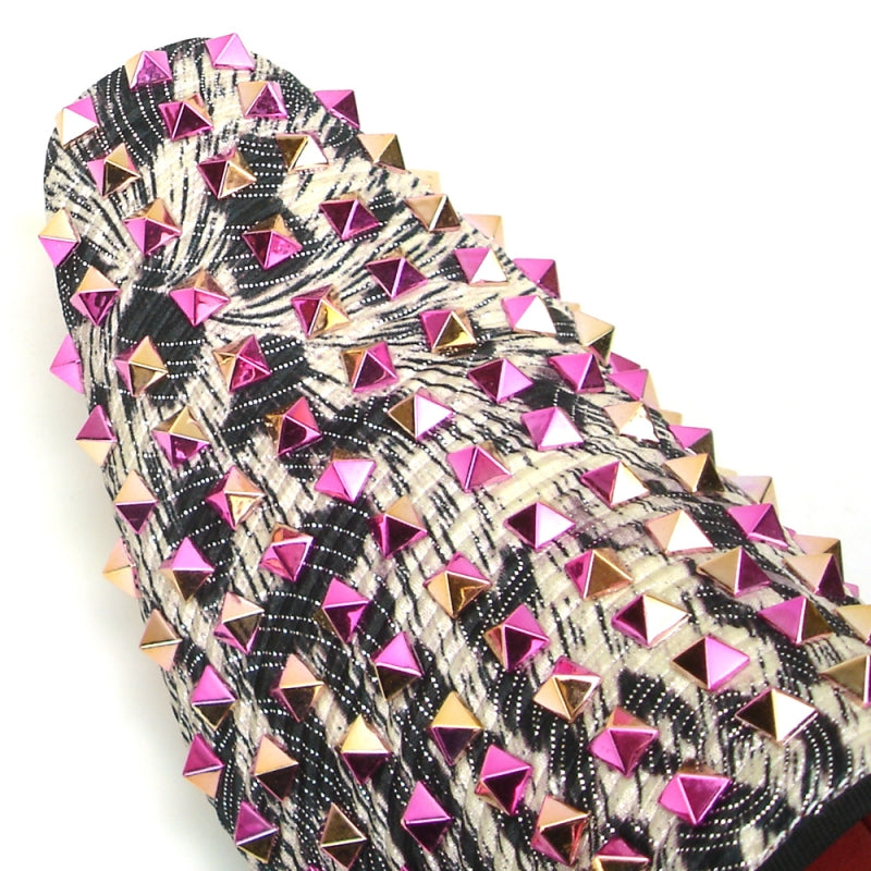 The FI-7496 Multi color Spike Slip on by Fiesso exudes edgy elegance with its black and white pattern, adorned with shiny pink and silver pyramid-shaped studs, reminiscent of leather spikes.