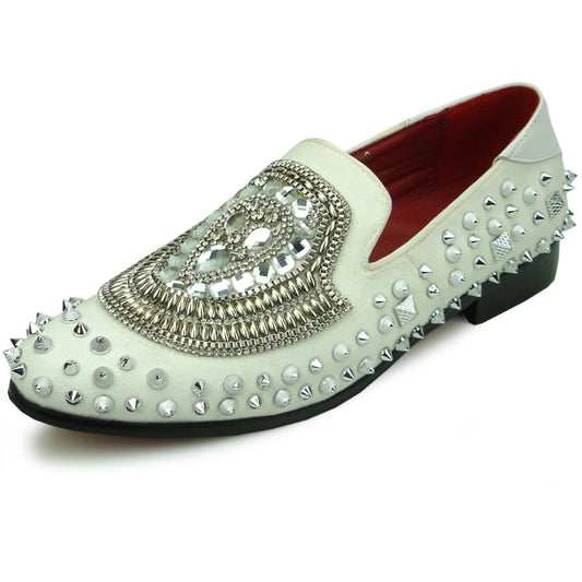 The FI-7500 White Suede Silver Stones Slip on by Fiesso combines edgy style with comfort. This design features a white suede exterior adorned with silver studs and a skull motif. It includes a cushioned insole for added comfort and is complemented by a striking red interior to complete the bold look.