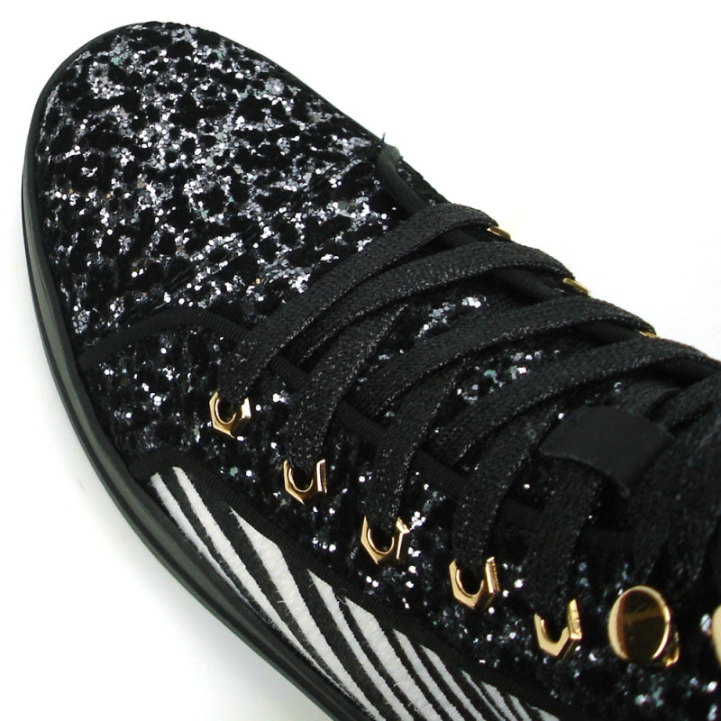 Introducing the FI-2347 Black-Zebra Black Sole High Top Sneakers Encore by Fiesso, these men's casual high-top sneakers showcase a striking black and white zebra pattern along with a glittery texture. Adorned with gold studs and black laces, they feature a leather upper. Designed for those who seek an edgy style, these sneakers are complete with bold spikes that make them stand out.