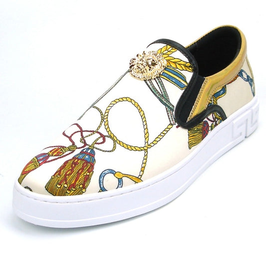 The FI-2383 Low Cut Sneaker Encore by Fiesso features a slip-on design made from micro leather, highlighted with a colorful pattern and topped with a gold lion detail, all set on a white sole.