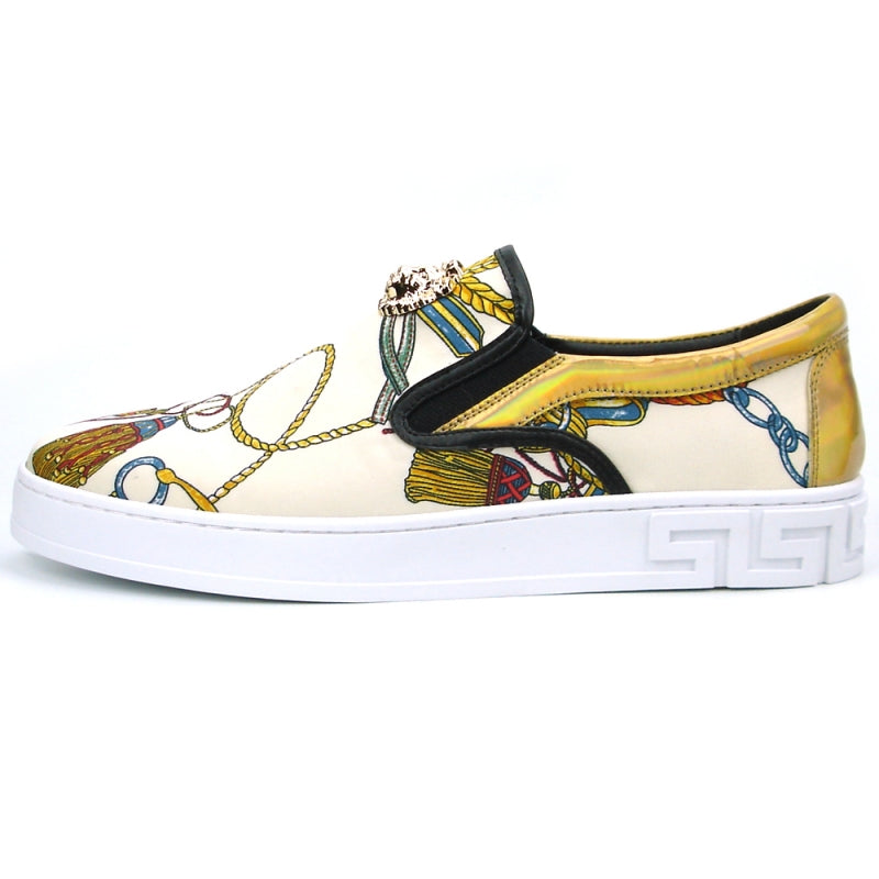 The FI-2383 Low Cut Sneaker Encore by Fiesso features a slip-on design made from micro leather, highlighted with a colorful pattern and topped with a gold lion detail, all set on a white sole.