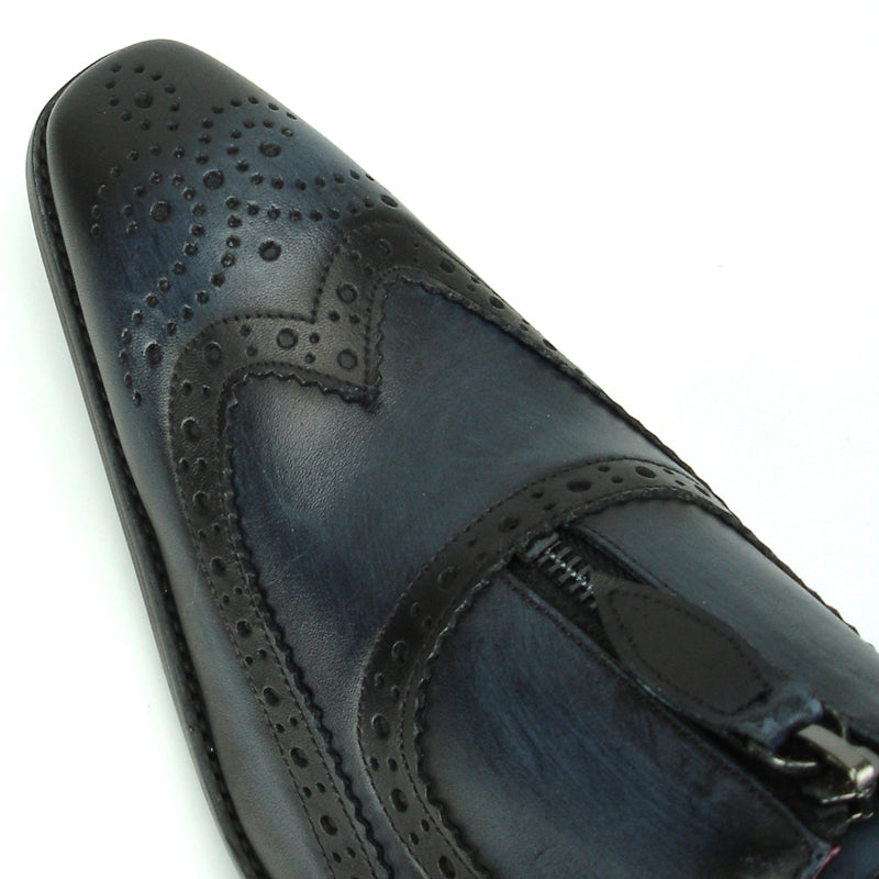 The FI-8714 Black Encore by Fiesso Slip-on Shoe showcases a stylish black and blue leather brogue design with a zipper, adorned with intricate perforated details. It features a vibrant red interior lining and offers enhanced comfort with a cushioned insole.