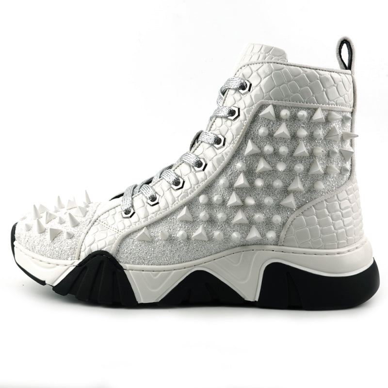 Introducing the FI-2405 White Spikes High Top Sneakers Encore by Fiesso, a striking fashion-forward design from Fiesso. These sneakers boast a textured white exterior accented with shimmering silver laces and adorned with numerous glittering spikes across the sides and front. The look is completed with a bold chunky black-and-white sole that instantly catches the eye.