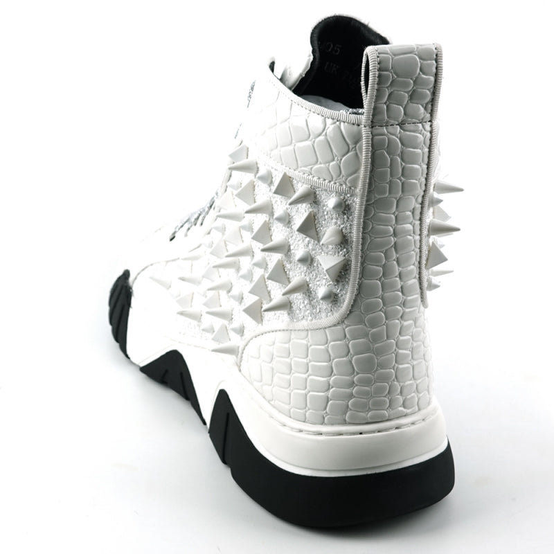 Introducing the FI-2405 White Spikes High Top Sneakers Encore by Fiesso, a striking fashion-forward design from Fiesso. These sneakers boast a textured white exterior accented with shimmering silver laces and adorned with numerous glittering spikes across the sides and front. The look is completed with a bold chunky black-and-white sole that instantly catches the eye.