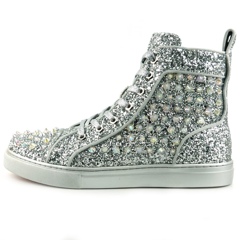 The FI-2409 Silver Glitter Black Spikes Encore by Fiesso is a striking high-top sneaker that shimmers with silver glitter and features eye-catching black spikes and rhinestones. It showcases a dazzling glitter upper, paired with fresh white laces and an immaculate white sole.