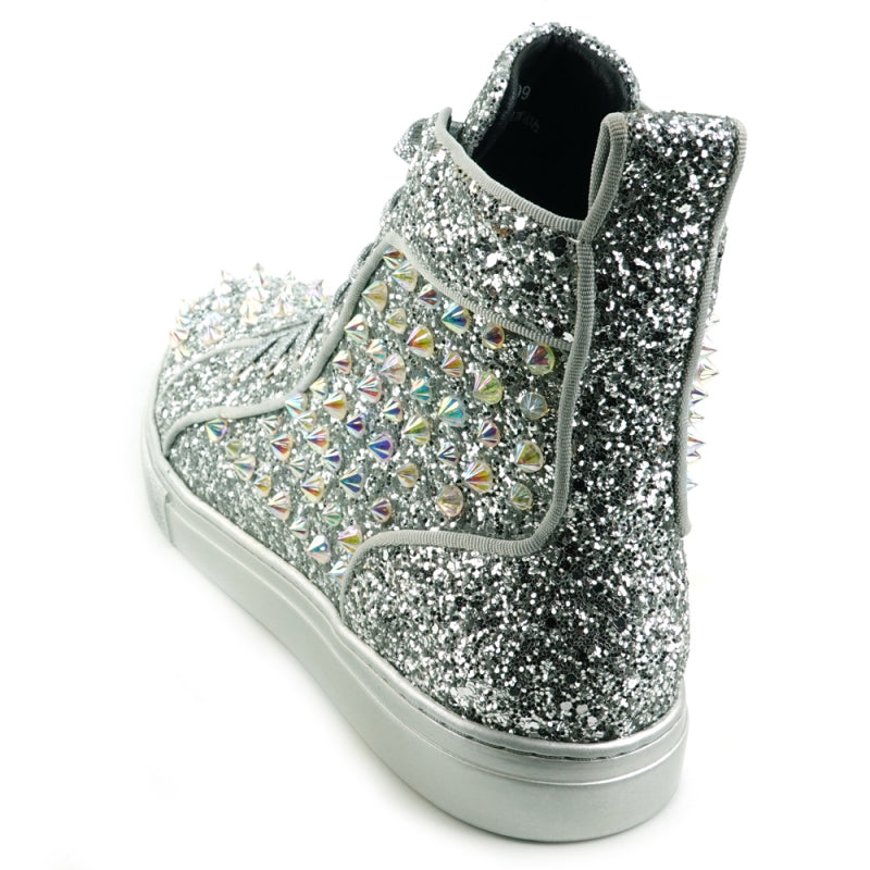 The FI-2409 Silver Glitter Black Spikes Encore by Fiesso is a striking high-top sneaker that shimmers with silver glitter and features eye-catching black spikes and rhinestones. It showcases a dazzling glitter upper, paired with fresh white laces and an immaculate white sole.