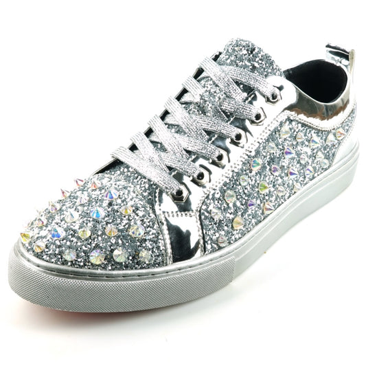 The FI-2413 Silver Glitter Spike Low Cut Sneaker Encore by Fiesso offers a stunning combination of sparkle and comfort, featuring a glitter upper embellished with large rhinestones, a reflective toe, cushioned insole, and white rubber sole.