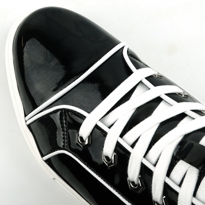 The FI-2416 high-top sneaker by Fiesso features sleek black patent leather, eye-catching white laces, and a clean white sole, all captured in a side view.