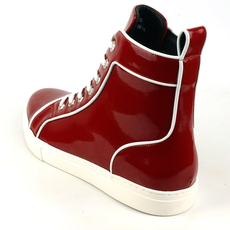 The FI-2416 Red Patent Leather High Top Sneaker by Fiesso is a striking piece with a glossy finish, adorned with white laces and trim, and featuring a white sole. It stands out against a plain background for an elegant and stylish look.