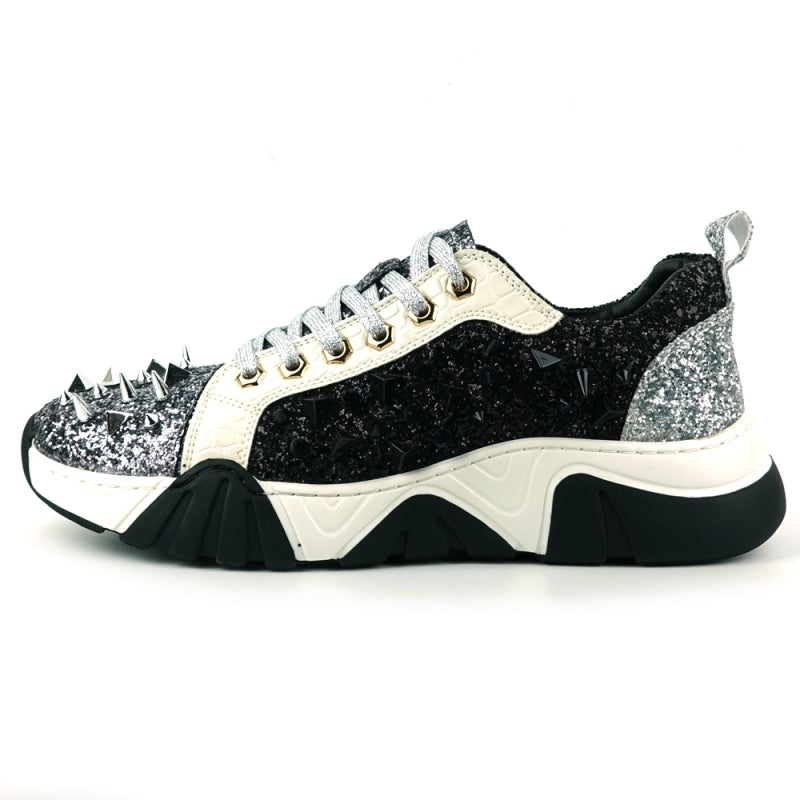 The FI-2406 Silver Black Encore by Fiesso is a sparkling men's casual sneaker featuring a glitter upper, black accents, metallic spikes on the front, white laces, a cushioned insole for enhanced comfort, and a thick black and white sole.