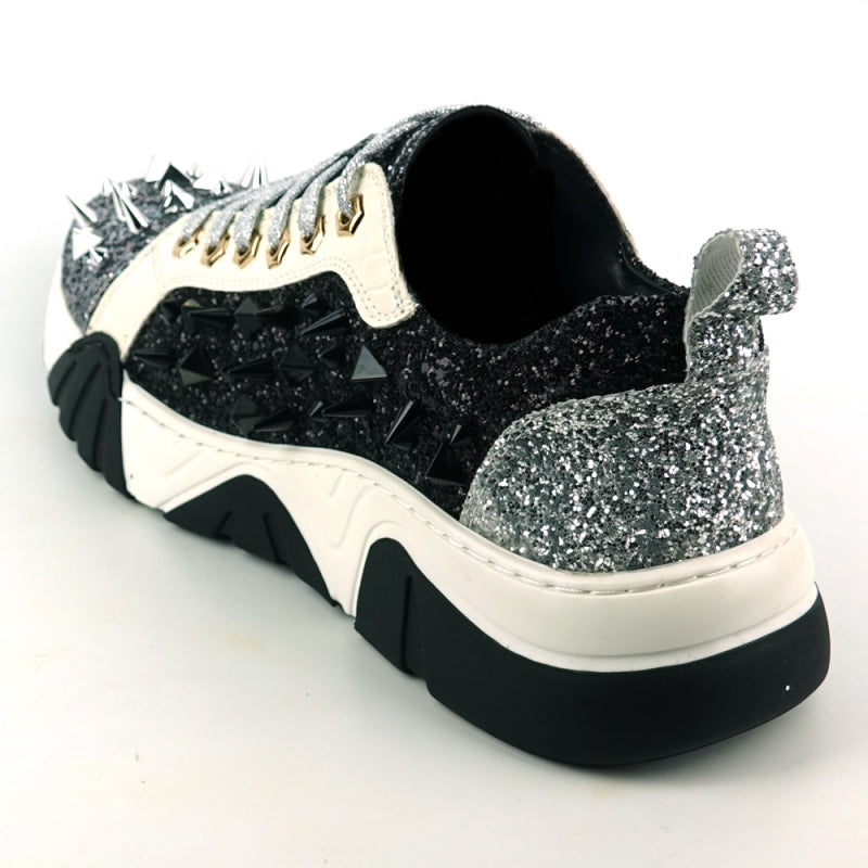 The FI-2406 Silver Black Encore by Fiesso is a sparkling men's casual sneaker featuring a glitter upper, black accents, metallic spikes on the front, white laces, a cushioned insole for enhanced comfort, and a thick black and white sole.