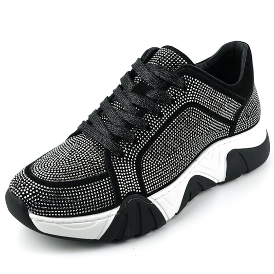 The FI-2407 Black Encore by Fiesso is a men's casual sneaker featuring a black and white design with suede detailing and rhinestone embellishments, complete with a thick black and white sole.