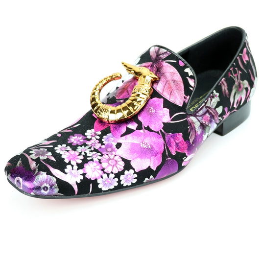 The FI-7259 Multicolor Slip On from Fiesso by Aurelio Garcia is a fashion shoe that features a floral-patterned design with pink and purple flowers on a black loafer, complemented by a gold decorative element on the front and equipped with a cushioned insole for ultimate comfort.