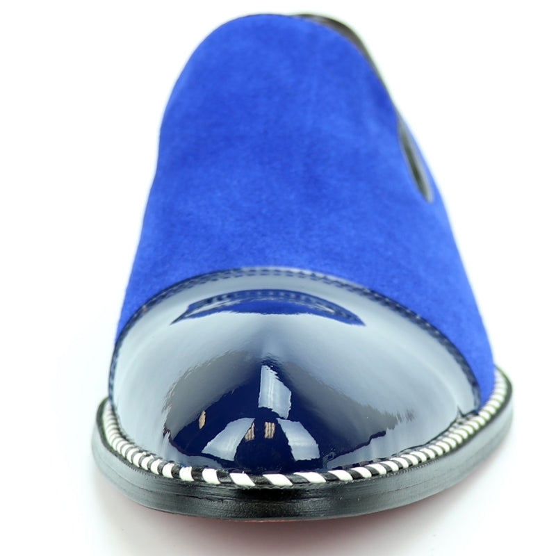 The Fiesso FI-7280 Blue Suede Cap Toe Slip On by Aurelio Garcia is a stylish shoe featuring a glossy patent leather toe cap and a sleek black sole.