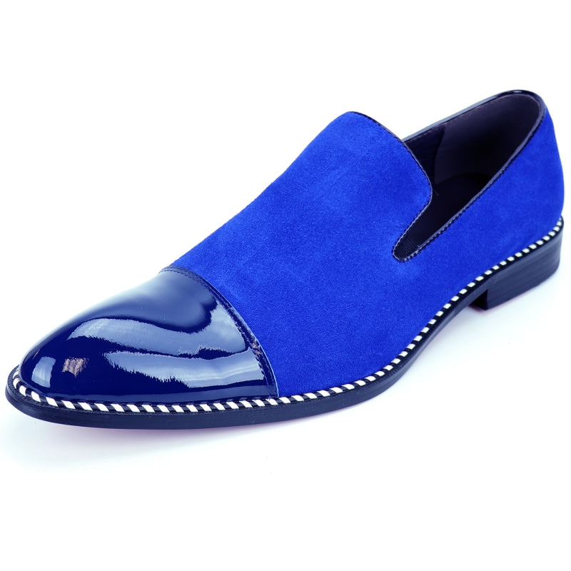 The Fiesso FI-7280 Blue Suede Cap Toe Slip On by Aurelio Garcia is a stylish shoe featuring a glossy patent leather toe cap and a sleek black sole.