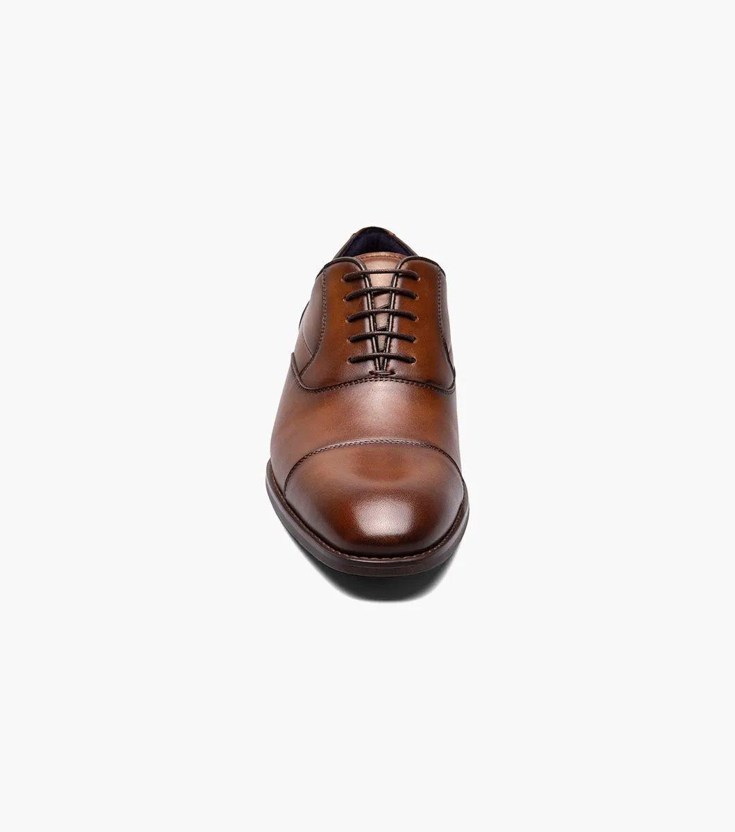 Introducing the Stacy Adams KALLUM Cap Toe Oxford in Cognac, featuring a cap toe and lace-up closure, along with a cushioned footbed for enhanced comfort.