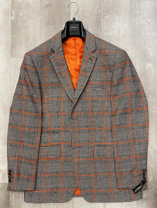 The Inserch Wool Blend Glenn Check Blazer in brown (BL002-25), available in sizes S and L, with an orange lining is elegantly displayed on a black hanger against a wooden backdrop.