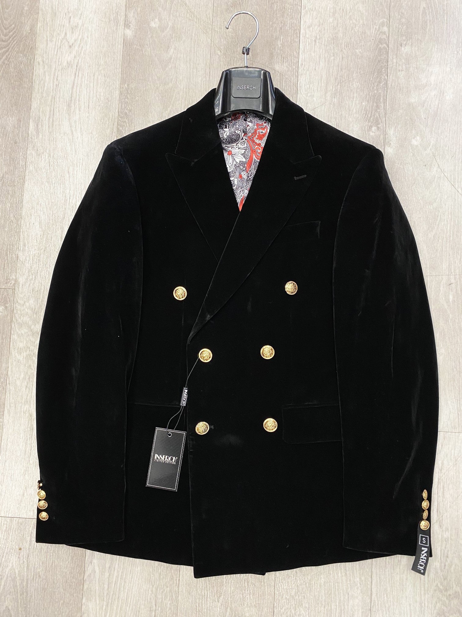 Product Data: The Inserch Double Breasted Velvet Peak Lapel Blazer in black (model BL502) features gold military shank buttons against a solid backdrop. The colorful patterned inside lining adds a surprising touch of flair.