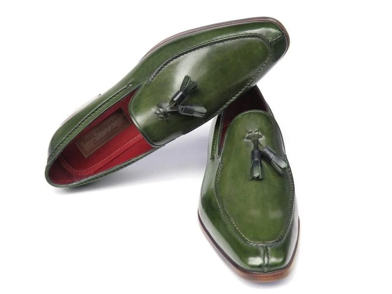 These striking Paul Parkman Tassel Loafers, labeled 083-GREEN, are crafted from hand-painted green leather and feature luxurious red interiors and elegant wooden heels.