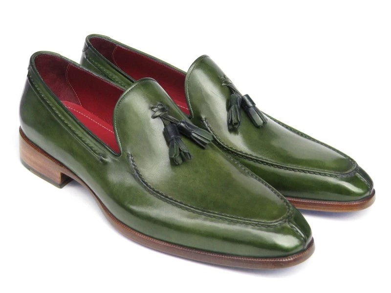 These striking Paul Parkman Tassel Loafers, labeled 083-GREEN, are crafted from hand-painted green leather and feature luxurious red interiors and elegant wooden heels.